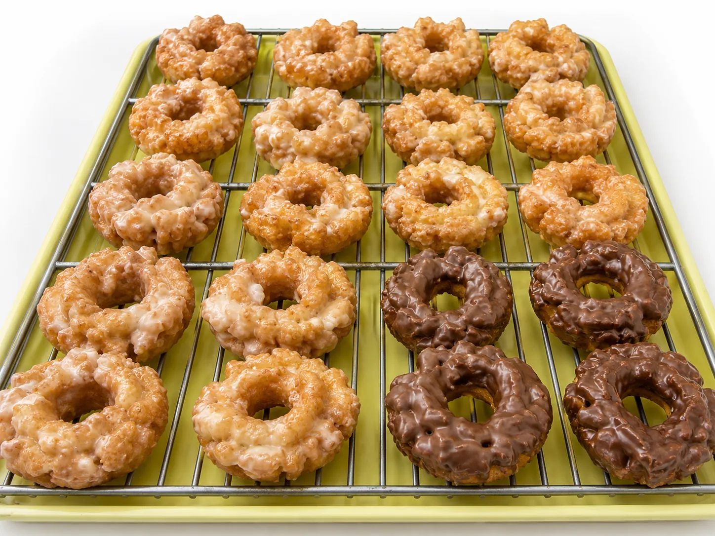 Craggy glazed old fashioned cake donuts on a gold tray at Atlanta Donuts.